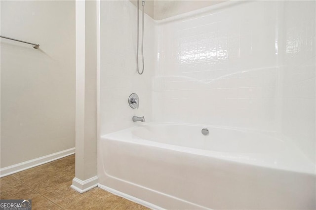 bathroom featuring shower / bathtub combination, baseboards, and tile patterned floors