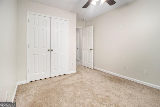 unfurnished bedroom featuring carpet floors, baseboards, and a closet