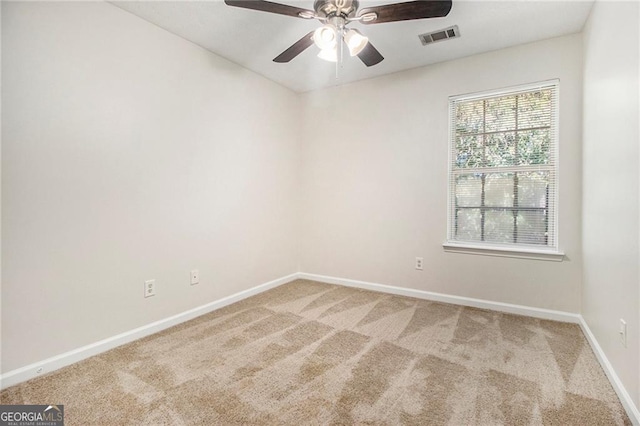 unfurnished room featuring carpet, visible vents, ceiling fan, and baseboards