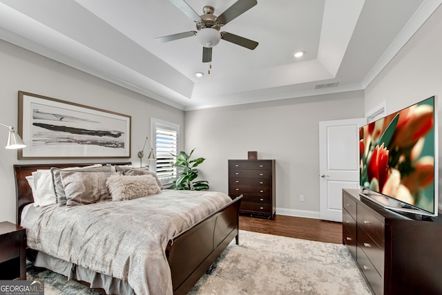 bedroom with baseboards, a raised ceiling, dark wood finished floors, ceiling fan, and recessed lighting