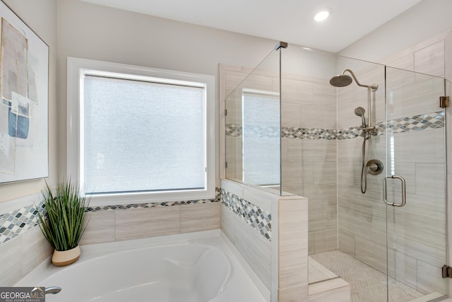 bathroom featuring a stall shower and a garden tub