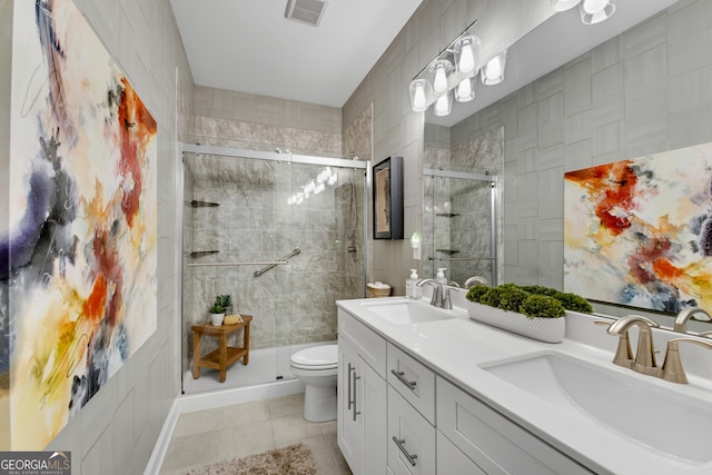 bathroom with tile patterned flooring, visible vents, a sink, and a shower stall