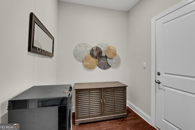 interior space featuring baseboards and wood finished floors