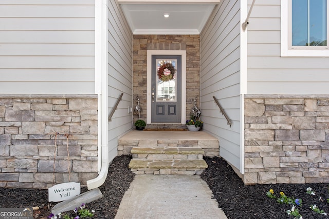 doorway to property featuring stone siding