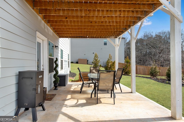 view of patio featuring outdoor dining space and fence