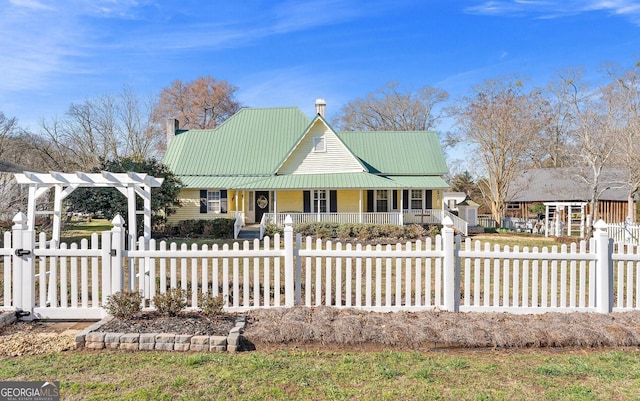 country-style home featuring covered porch, metal roof, a fenced front yard, and a pergola