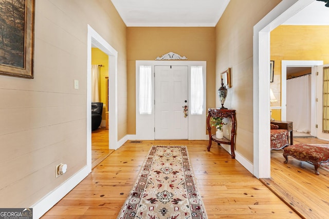 entryway with light wood-style floors and baseboards