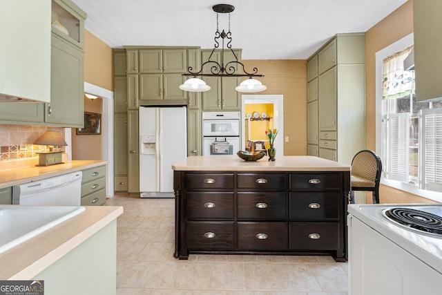 kitchen featuring white appliances, light countertops, plenty of natural light, and green cabinets