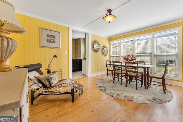 dining space with baseboards and light wood-style floors