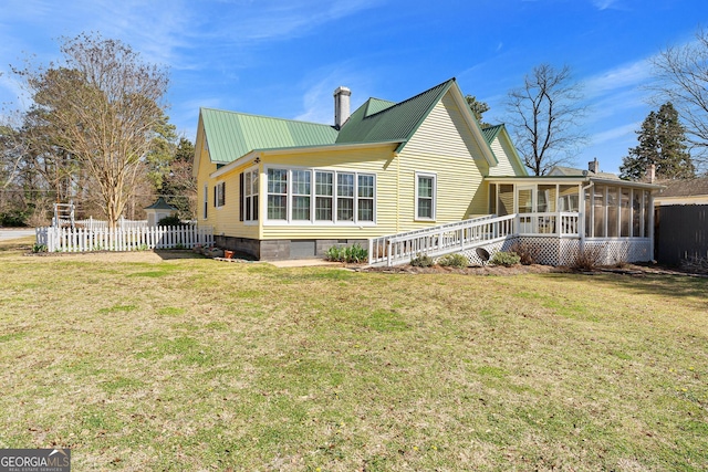 back of house with metal roof, fence, a sunroom, crawl space, and a chimney