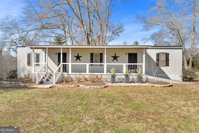 manufactured / mobile home with covered porch and a front yard