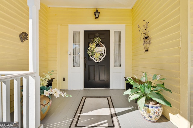 view of exterior entry featuring a porch