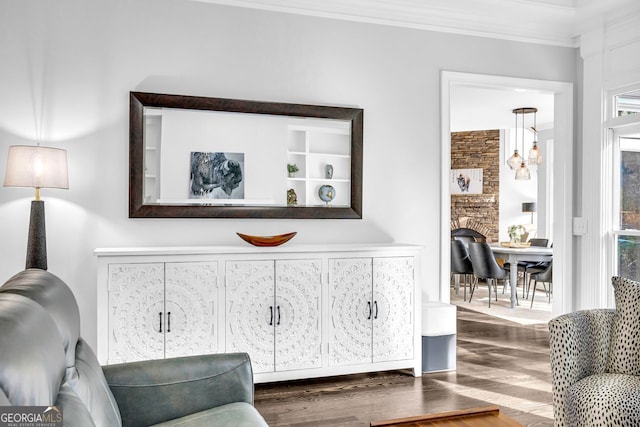 living area featuring crown molding and wood finished floors