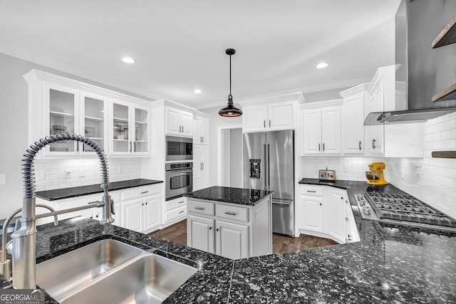 kitchen with a sink, stainless steel appliances, ventilation hood, and white cabinetry