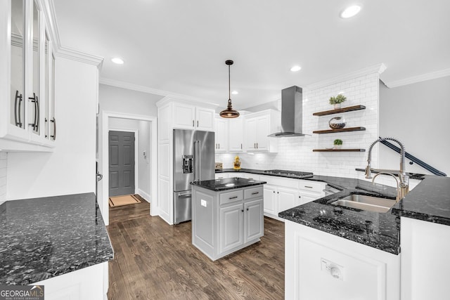 kitchen with a sink, open shelves, appliances with stainless steel finishes, wall chimney exhaust hood, and crown molding