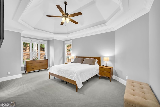 bedroom featuring light carpet, crown molding, a raised ceiling, and baseboards