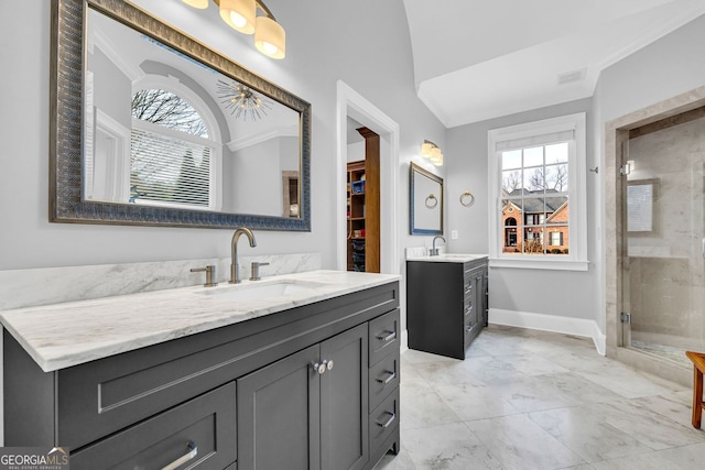 full bath featuring visible vents, two vanities, a sink, a shower stall, and baseboards