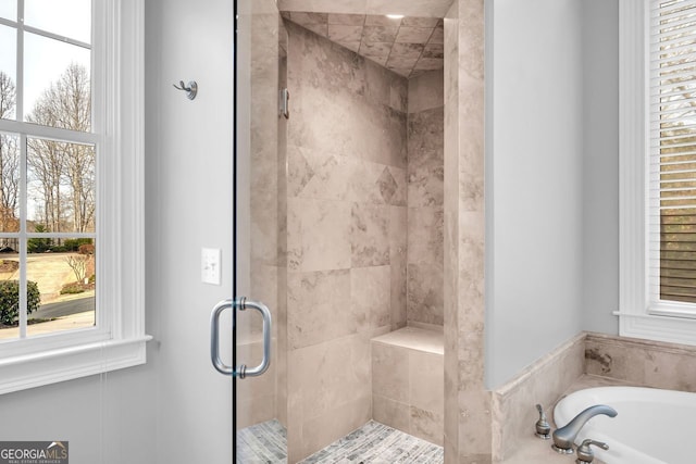 bathroom featuring a bath and a stall shower