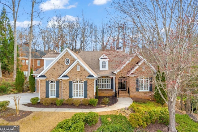 view of front facade with brick siding and concrete driveway