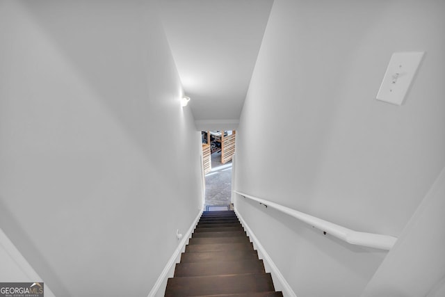 stairs featuring baseboards and wood finished floors