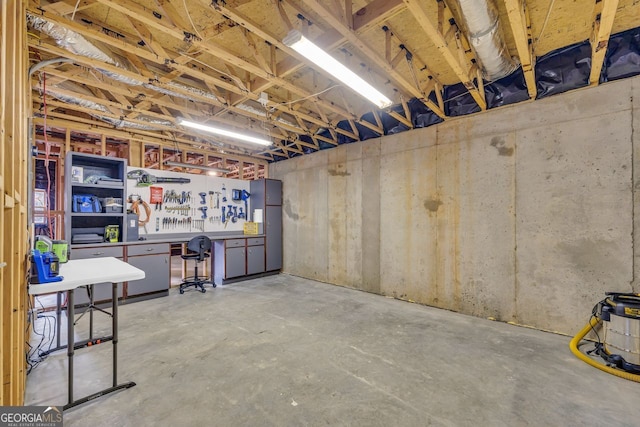 basement featuring freestanding refrigerator