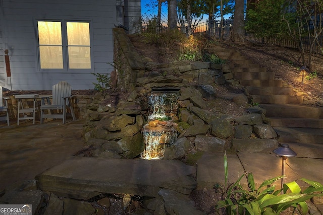 exterior space with a garden pond and a patio area