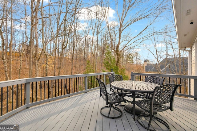 wooden deck featuring outdoor dining area