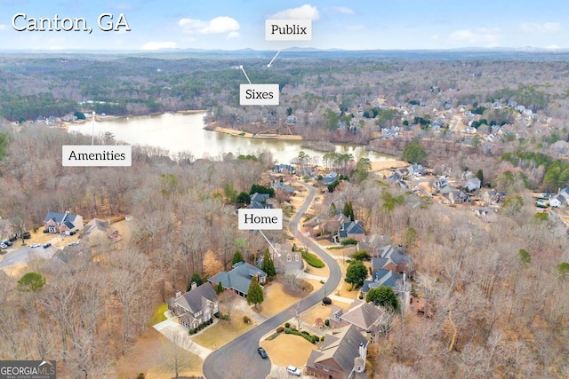 aerial view featuring a view of trees and a water view