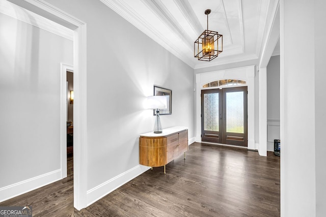 entrance foyer featuring dark wood-style floors, baseboards, french doors, crown molding, and a notable chandelier