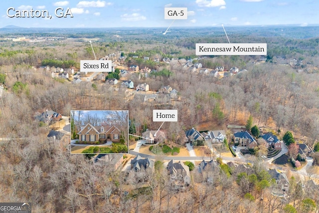 birds eye view of property with a forest view and a residential view