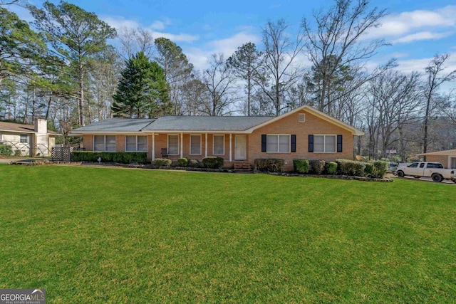 ranch-style home with a front yard and brick siding