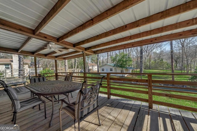 deck featuring a ceiling fan and outdoor dining area