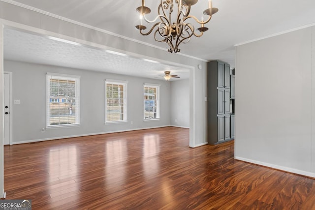 unfurnished living room featuring ornamental molding, dark wood finished floors, a ceiling fan, and baseboards