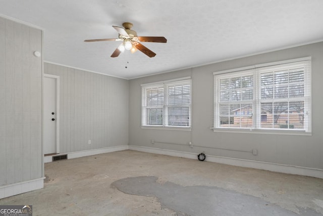 unfurnished room featuring ornamental molding, a healthy amount of sunlight, and visible vents