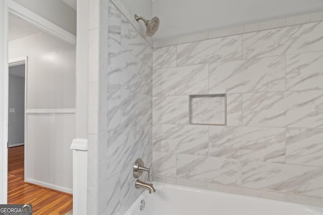 bathroom featuring shower / bathing tub combination and wood finished floors