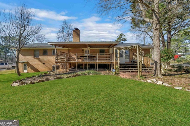 back of house with a yard, stairway, a chimney, and a wooden deck