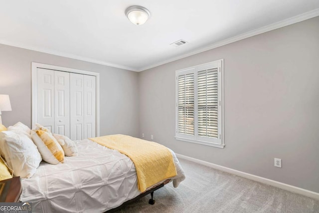 carpeted bedroom with baseboards, crown molding, visible vents, and a closet