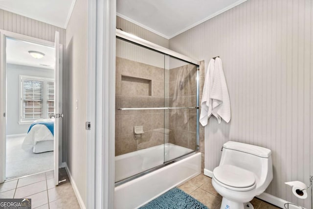 ensuite bathroom with crown molding, toilet, ensuite bathroom, combined bath / shower with glass door, and tile patterned floors