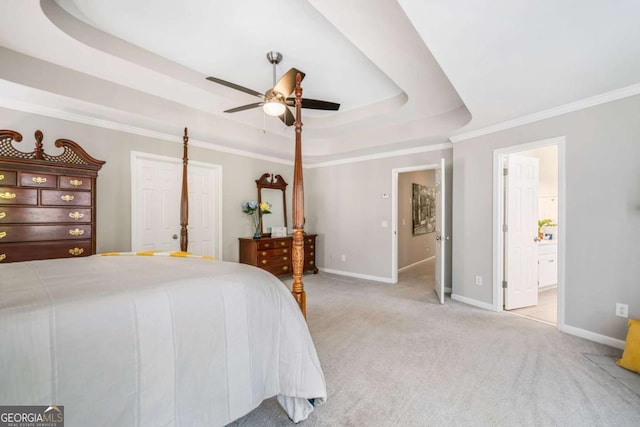 bedroom with baseboards, a raised ceiling, crown molding, and light colored carpet