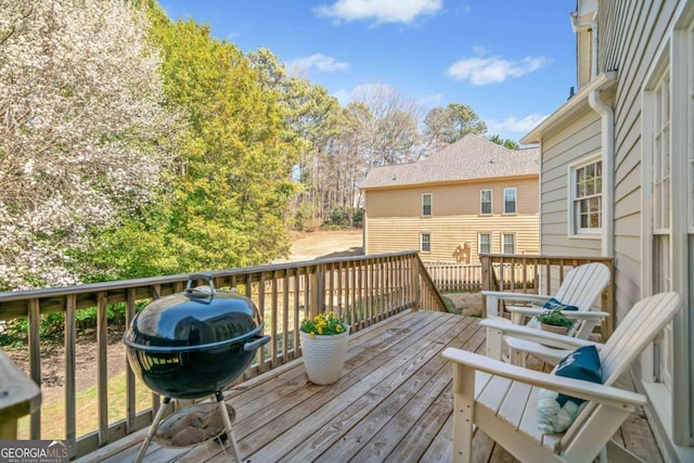 wooden terrace featuring a grill