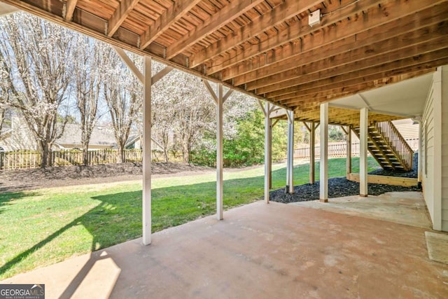 view of patio / terrace featuring stairs and fence