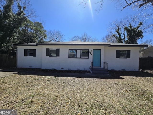 ranch-style house featuring crawl space, fence, and brick siding