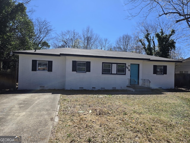 single story home with brick siding, crawl space, a front lawn, and fence