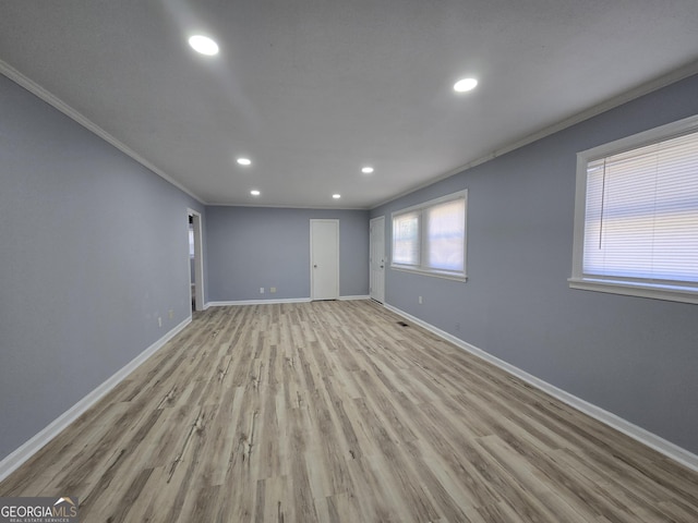 empty room with recessed lighting, crown molding, baseboards, and wood finished floors