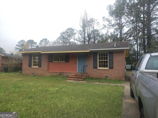 view of front of property featuring a front yard, brick siding, and crawl space