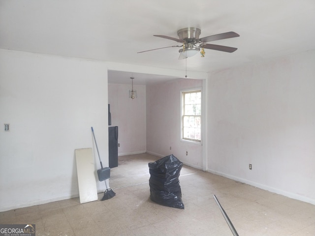 empty room with tile patterned floors, baseboards, and a ceiling fan