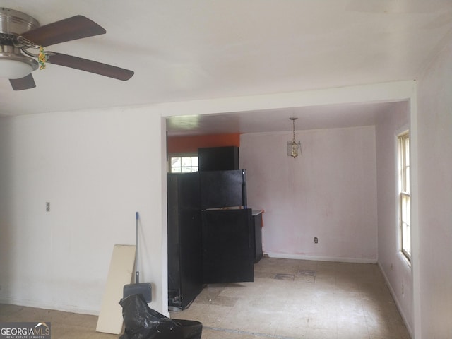 unfurnished living room with baseboards