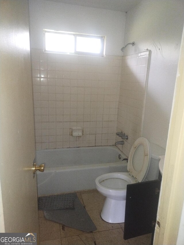 full bathroom with shower / bathing tub combination, toilet, and tile patterned floors