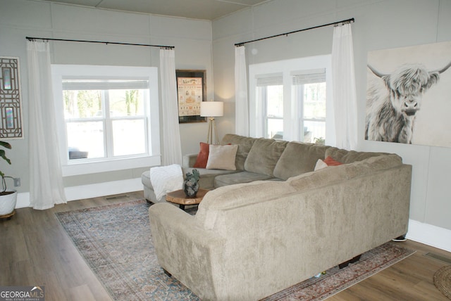 living room featuring plenty of natural light, wood finished floors, and visible vents