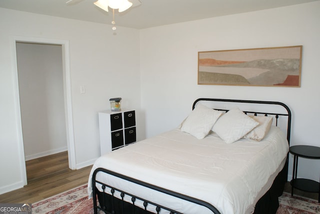 bedroom with wood finished floors and baseboards